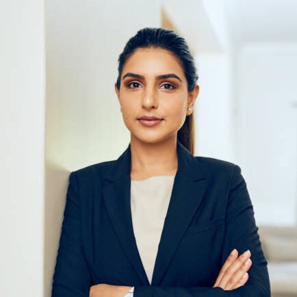 Home portrait of a young woman standing in an office